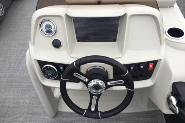 Slide: The Image of 2023 Starcraft LX 18 R boat dashboard with steering wheel and control panel. - 5