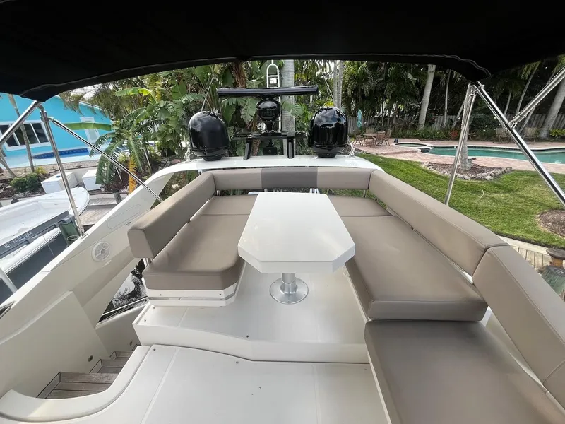 Slide: The Image of 2017 Marquis 500 Sport Yacht with outdoor seating and table. - 13