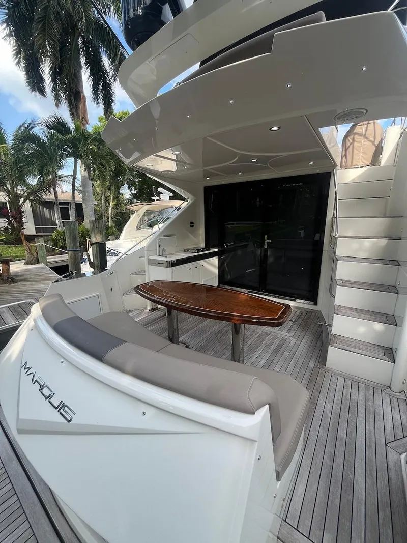 Slide: The Image of 2017 Marquis 500 Sport Yacht deck with seating and table. - 21