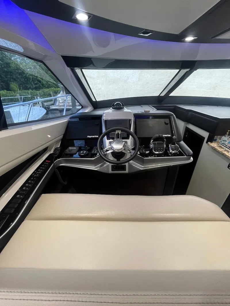 Slide: The Image of 2017 Marquis 500 Sport Yacht helm with modern navigation controls and luxurious seating. - 27