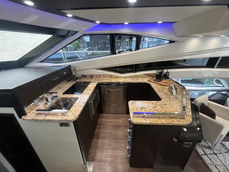 Slide: The Image of Modern kitchen in 2017 Marquis 500 Sport Yacht with granite countertops and stainless steel appliances. - 29
