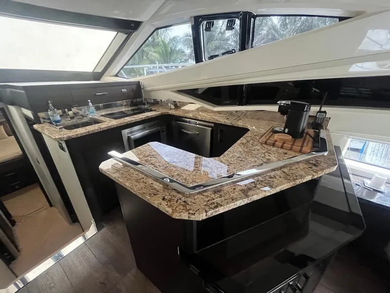 Slide: The Image of 2017 Marquis 500 Sport Yacht kitchen with granite countertops and modern appliances. - 34