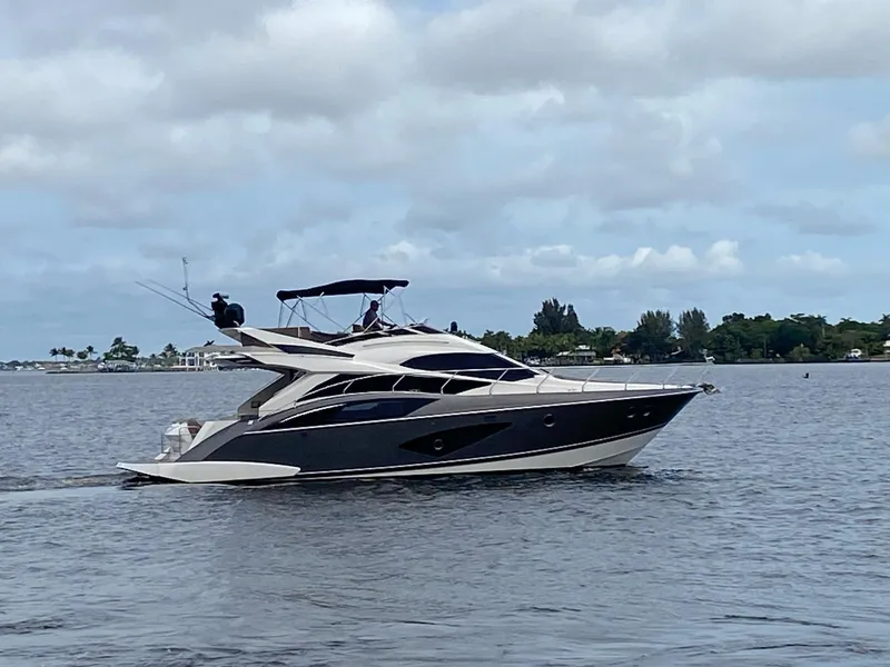 Slide: The Image of 2017 Marquis 500 Sport Yacht cruising on a calm lake. - 6