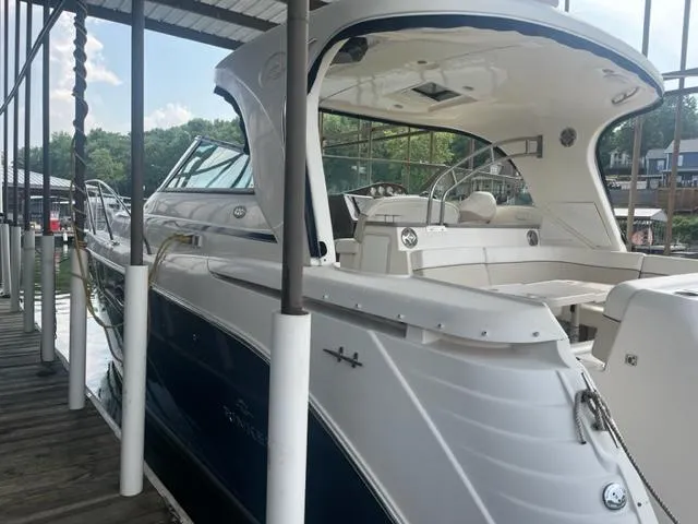 Slide: The Image of 2007 Rinker 420 Express Cruiser docked at a marina. - 10