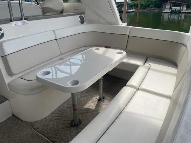 Slide: The Image of 2007 Rinker 420 Express Cruiser interior seating area with table. - 2