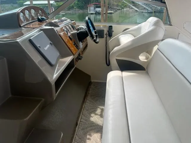 Slide: The Image of 2007 Rinker 420 Express Cruiser helm with leather seating and control panel. - 4