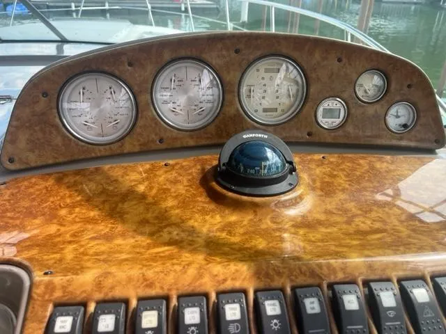Slide: The Image of Dashboard of a 2007 Rinker 420 Express Cruiser with gauges and compass. - 6