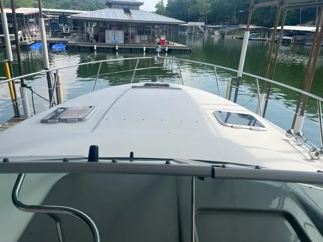 Slide: The Image of 2007 Rinker 420 Express Cruiser docked at a marina. - 8