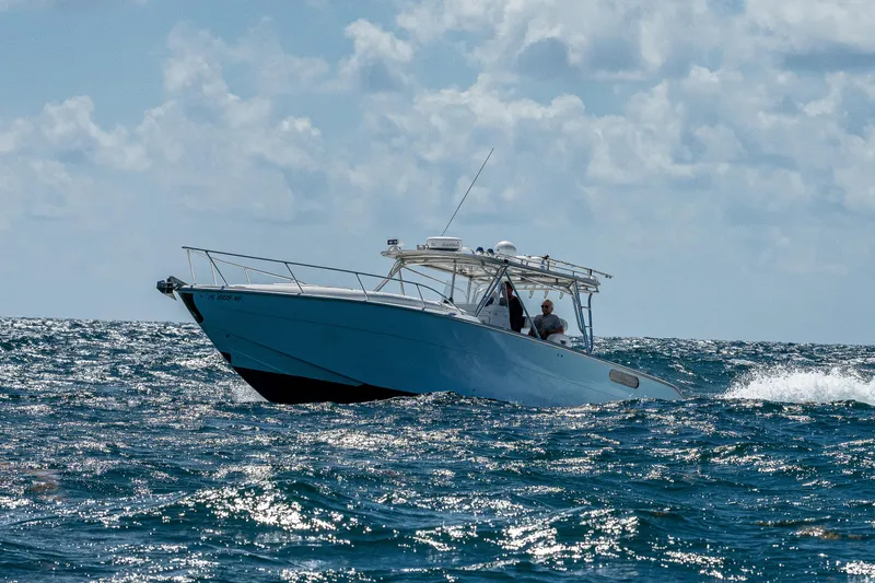 Slide: The Image of 2007 Marlin Yachts 42 cruising on open water under a partly cloudy sky. - 12
