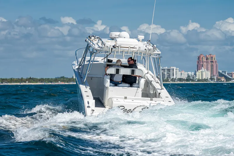 Slide: The Image of 2007 Marlin Yachts 42 cruising on the ocean near a city skyline. - 3