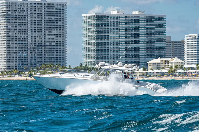 Slide: The Image of 2007 Marlin Yachts 42 cruising in choppy waters near high-rise buildings. - 8