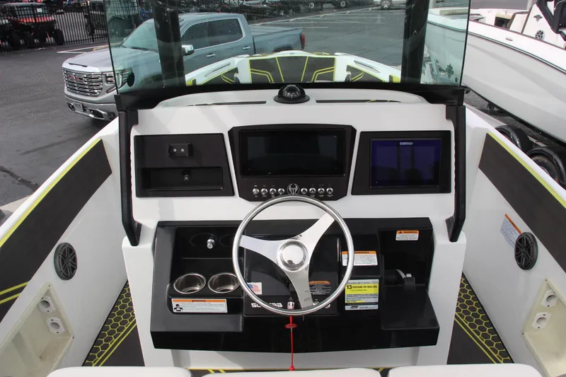 Slide: The Image of 2023 Scarab 255 Open ID boat dashboard with steering wheel and controls. - 11