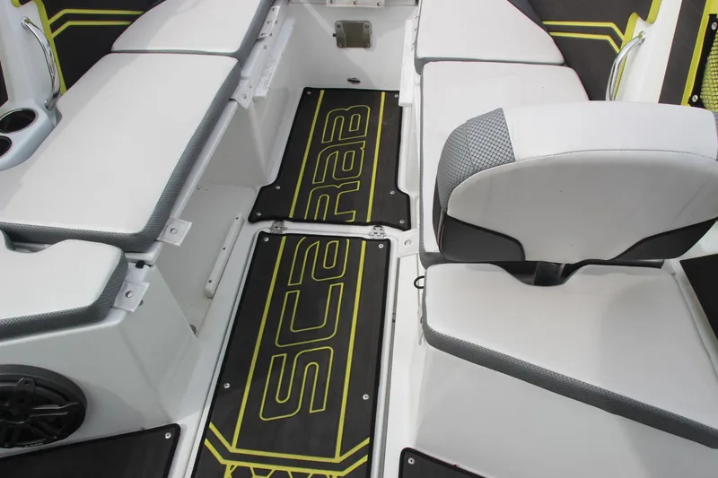Slide: The Image of 2023 Scarab 255 Open ID boat interior with seating and branded flooring. - 16