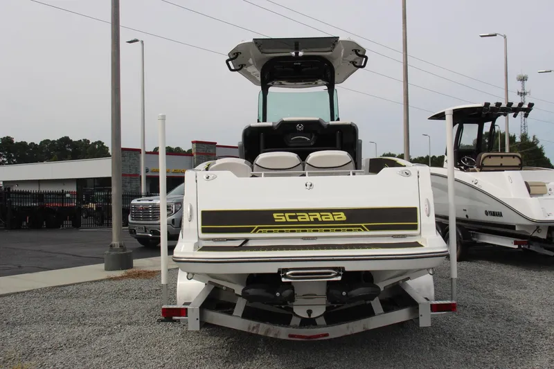 Slide: The Image of 2023 Scarab 255 Open ID boat displayed at a dealership. - 4