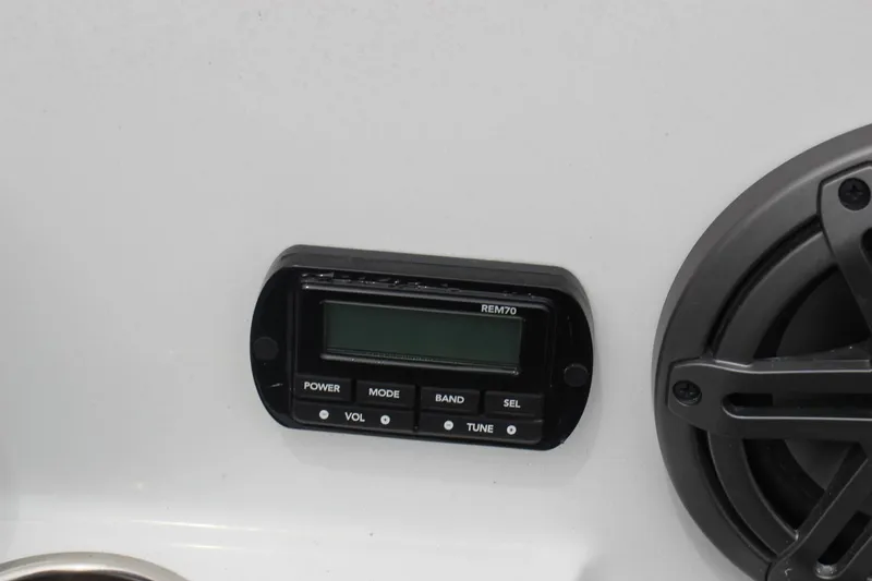 Slide: The Image of Control panel and speaker on 2023 Scarab 255 Open ID boat. - 15
