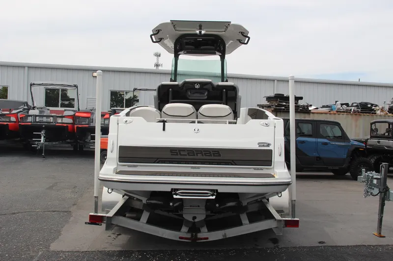 Slide: The Image of 2023 Scarab 255 Open ID boat on trailer, rear view in a parking lot. - 4