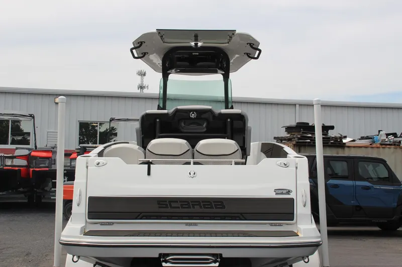 Slide: The Image of 2023 Scarab 255 Open ID boat, rear view, in a storage yard. - 5