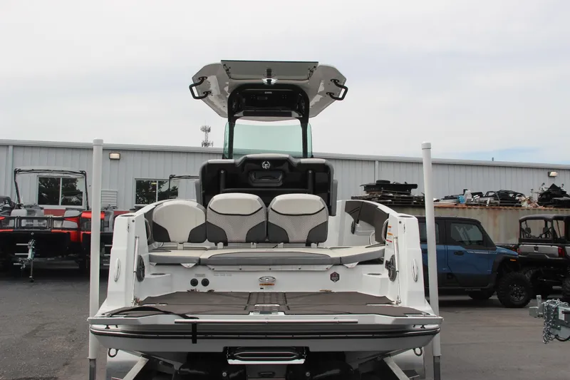 Slide: The Image of 2023 Scarab 255 Open ID boat, rear view, in a parking lot. - 7