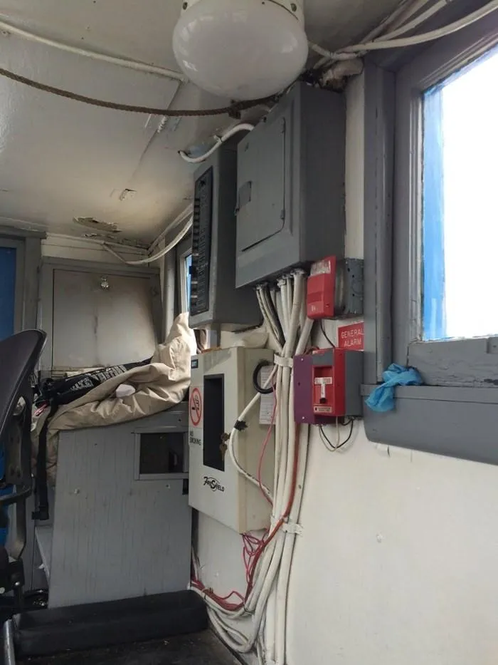 Slide: The Image of Interior of 1903 Johnson Brother Tug 64 with electrical panels and safety equipment. - 11