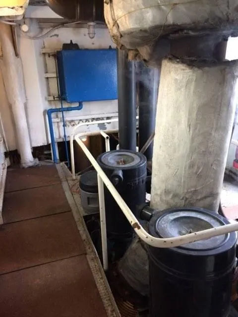 Slide: The Image of Engine room of 1903 Johnson Brother Tug 64 with machinery and pipes. - 12