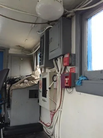 Slide: The Image of Electrical panel and wiring inside a 1903 Johnson Brother Tug 64 boat. - 18