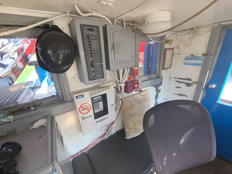 Slide: The Image of Interior of 1903 Johnson Brother Tug 64 with control panels and seating. - 27