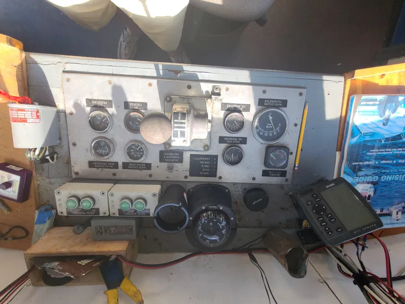 Slide: The Image of Control panel of a 1903 Johnson Brother Tug 64 boat with gauges and navigation equipment. - 31
