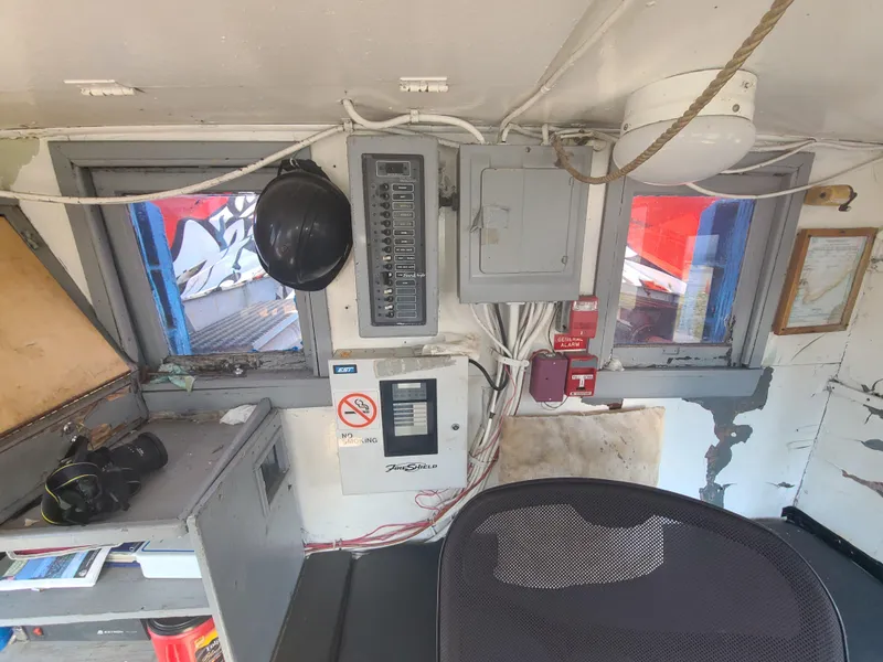 Slide: The Image of Control room of 1903 Johnson Brother Tug 64 with electrical panels and safety equipment. - 32