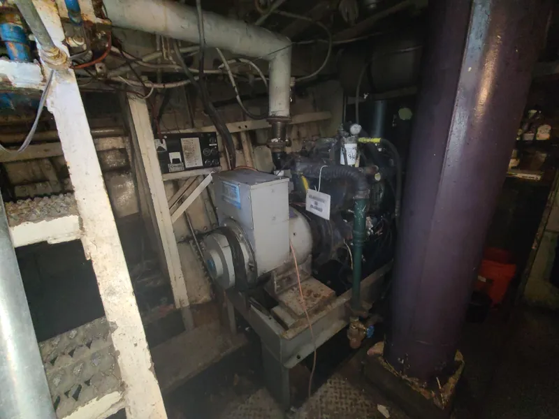 Slide: The Image of Engine room of a 1903 Johnson Brother Tug 64 with machinery and pipes. - 35