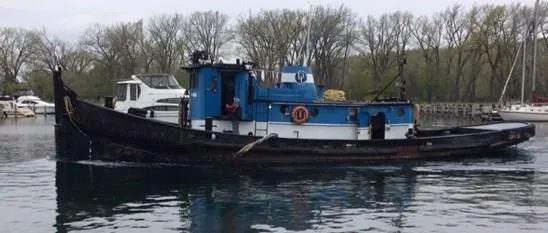 Slide: The Image of Vintage 1903 Johnson Brother Tug 64 on a calm river. - 4