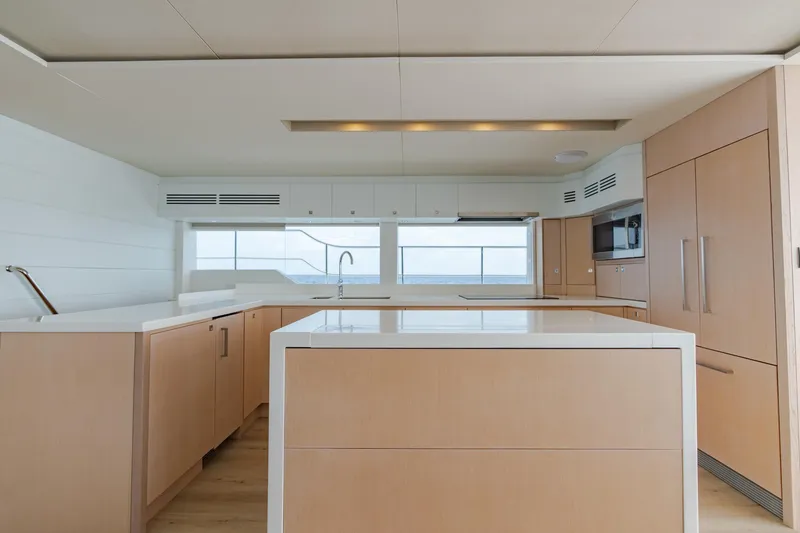 Slide: The Image of Modern kitchen interior on Two Oceans 555 yacht, 2025 model, featuring sleek cabinetry and ocean view. - 33