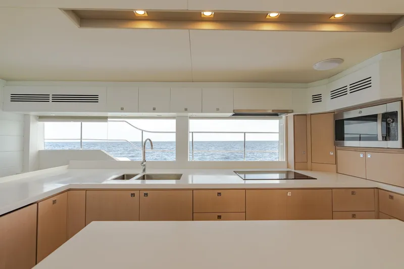 Slide: The Image of Modern kitchen on Two Oceans 555 yacht, 2025 model, with ocean view through large windows. - 34