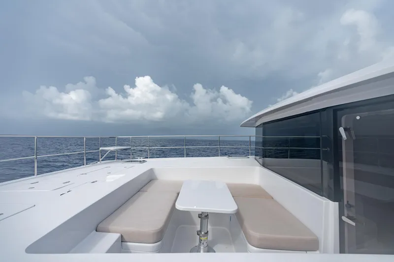 Slide: The Image of Two Oceans 555 yacht deck with seating area, ocean view, and cloudy sky, 2025 model. - 9