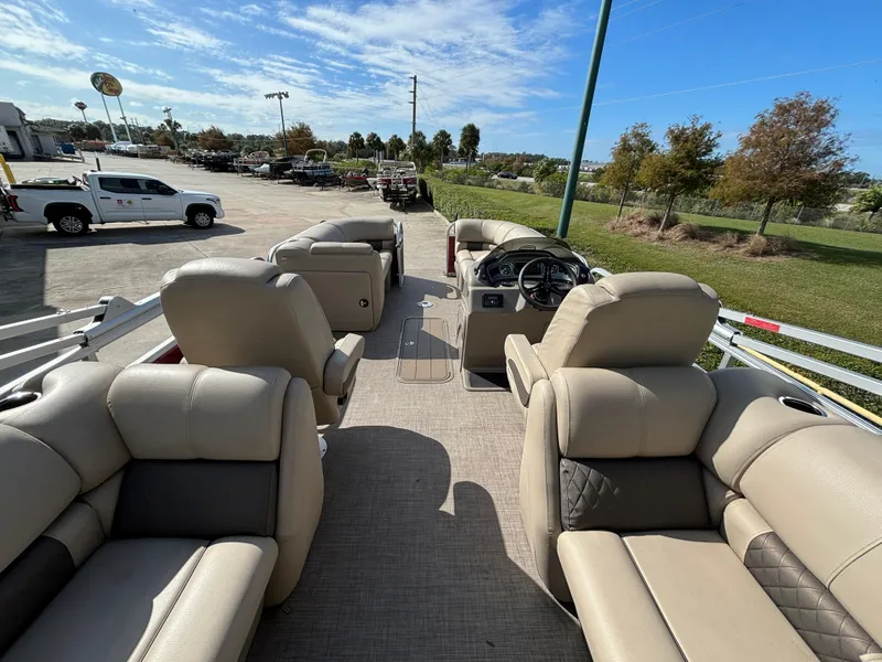 Slide: The Image of 2023 Sun Tracker Party Barge 22 XP3 interior with plush seating and steering console. - 3