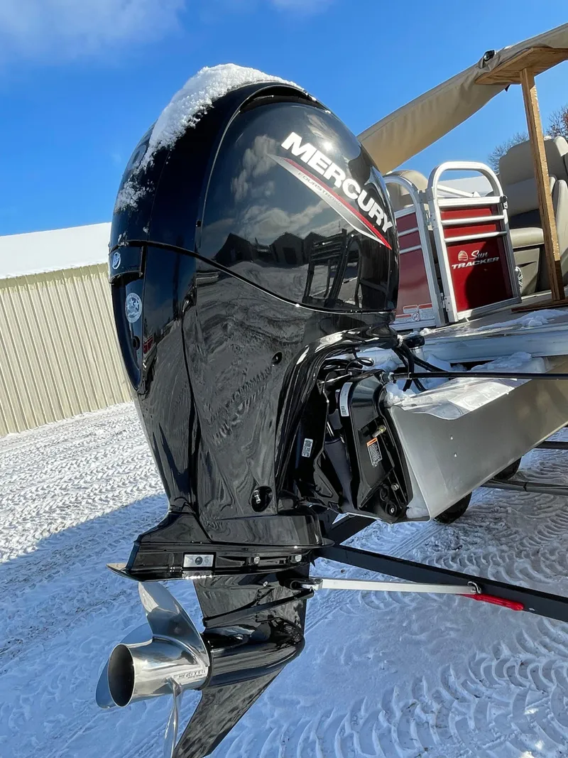 Slide: The Image of 2023 Sun Tracker Party Barge 22 DLX with Mercury outboard motor on snowy ground. - 3