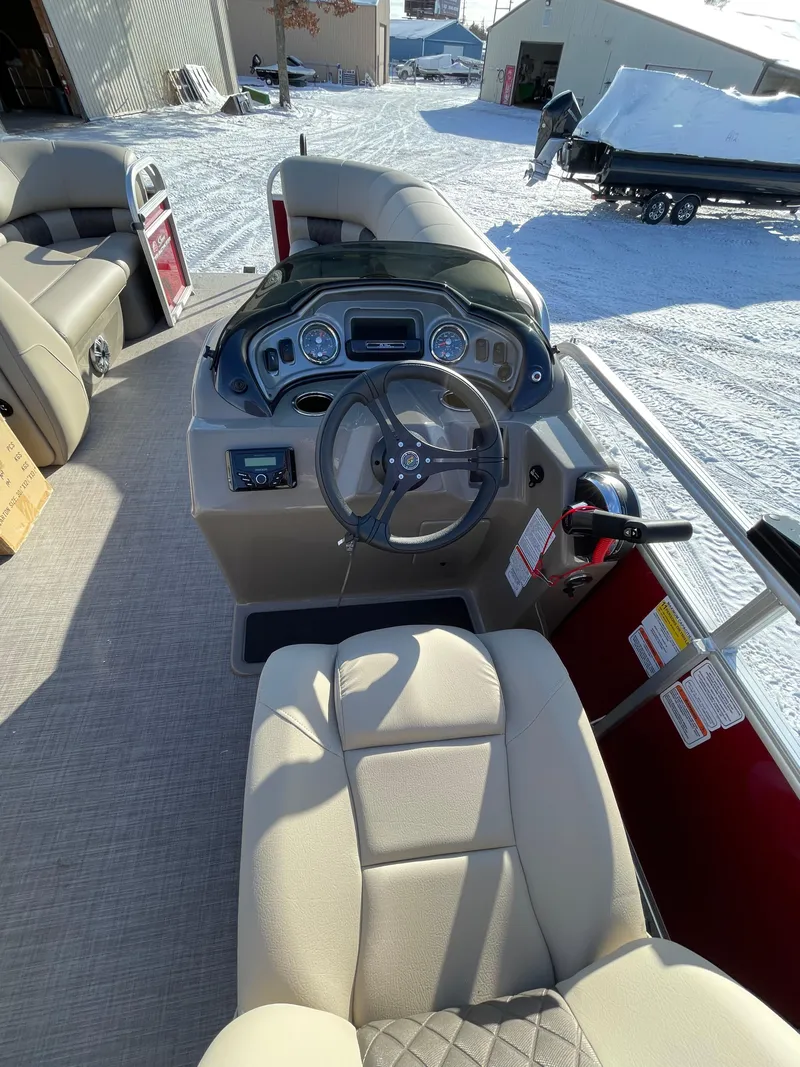 Slide: The Image of 2023 Sun Tracker Party Barge 22 DLX interior with steering console and seating. - 4