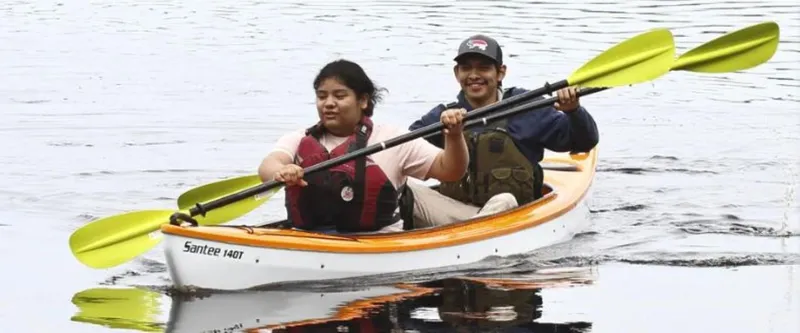 Slide: The Image of Two people kayaking in a 2023 Hurricane Kayaks Santee 140 Tandem. - 8