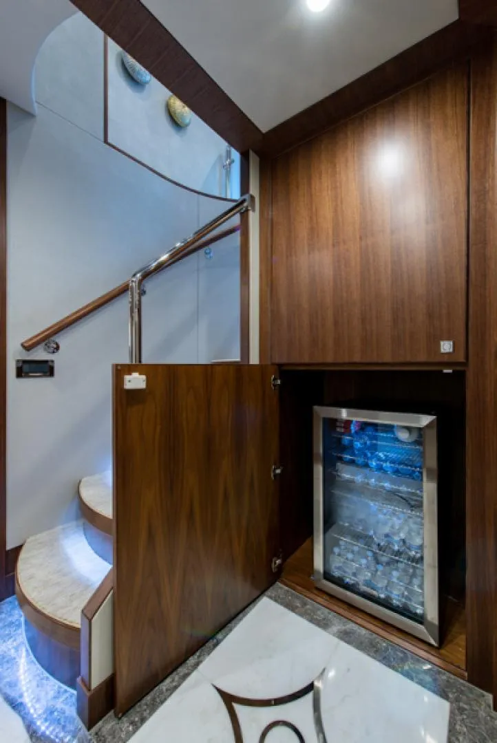 Slide: The Image of 2020 Hargrave G120 yacht interior with wooden cabinetry and mini fridge. - 17