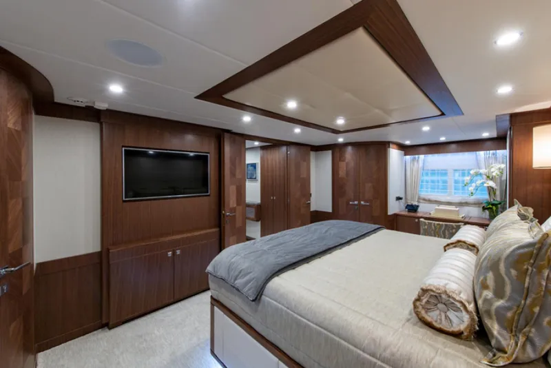 Slide: The Image of Luxurious bedroom interior of 2020 Hargrave G120 yacht with wood paneling and modern amenities. - 21