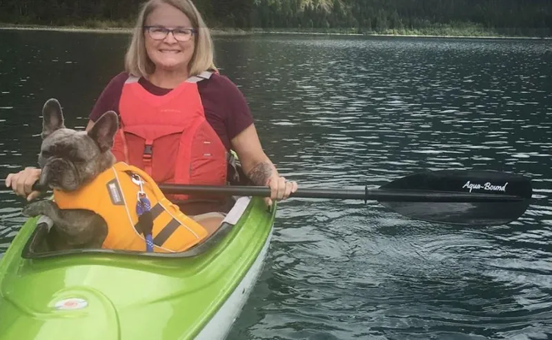 The Image of Woman kayaking with dog in a 2023 Hurricane Kayaks Santee 116 Sport. - 0