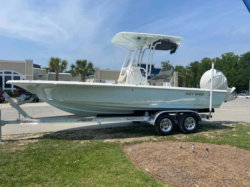 Slide: The Image of 2024 Key West 230 Bay Reef boat on a trailer in a parking lot. - 0