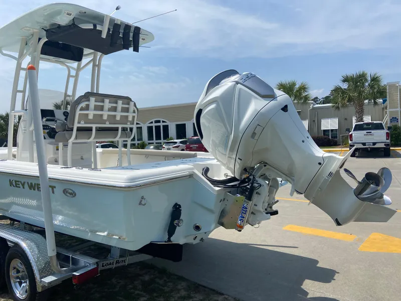 Slide: The Image of 2024 Key West 230 Bay Reef boat with outboard motor in parking lot. - 4