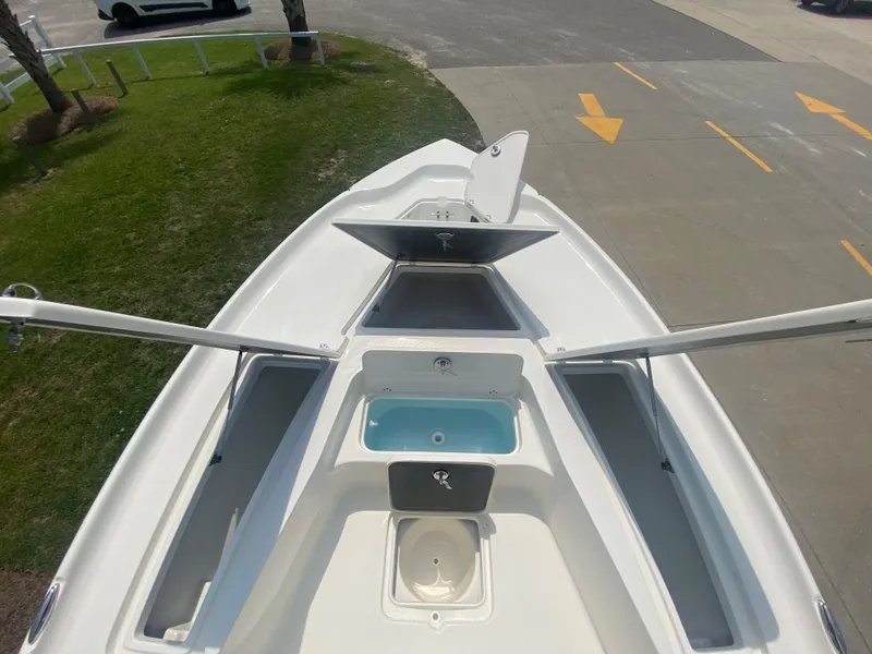 Slide: The Image of 2024 Key West 230 Bay Reef boat with open storage compartments. - 8