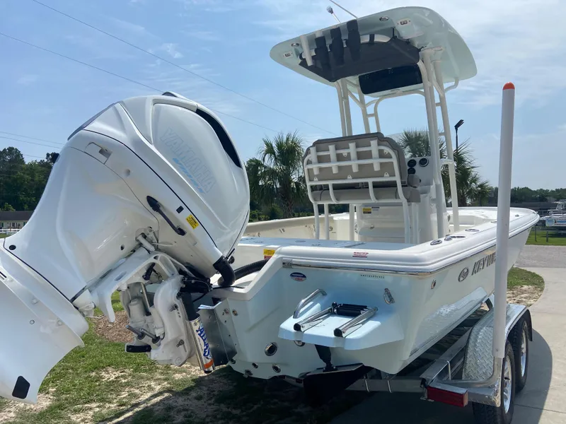 Slide: The Image of 2024 Key West 230 Bay Reef boat with outboard motor on trailer. - 5