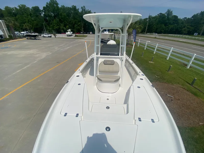 Slide: The Image of 2024 Key West 230 Bay Reef boat on display in a parking lot. - 7