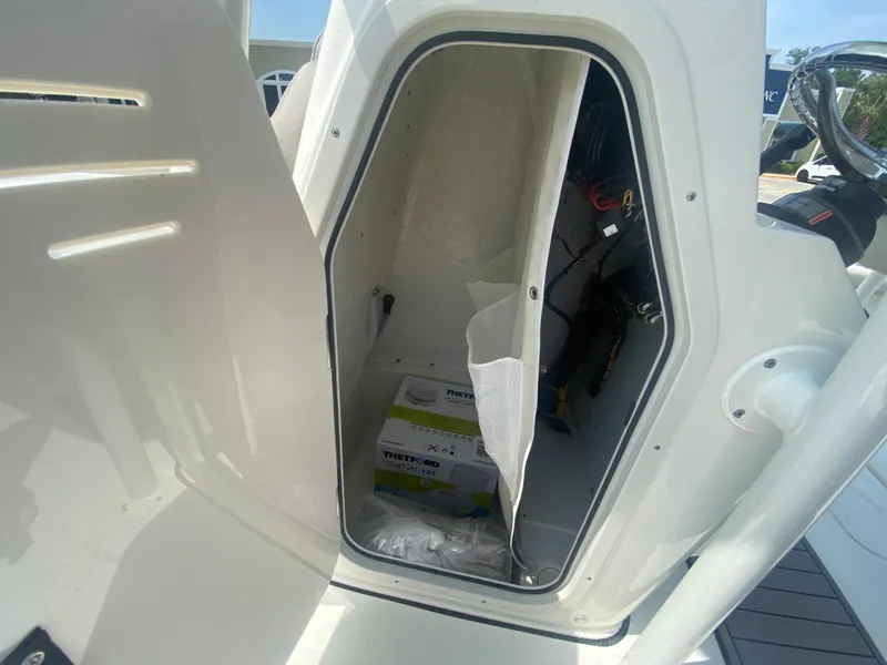 Slide: The Image of 2024 Key West 230 Bay Reef storage compartment with equipment. - 12