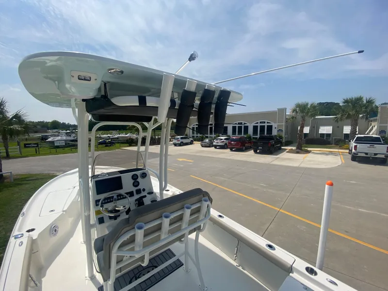Slide: The Image of 2024 Key West 230 Bay Reef boat with T-top and console, docked in a marina. - 22
