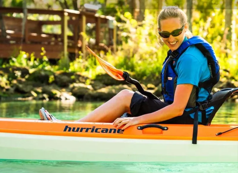 The Image of Woman kayaking in a 2023 Hurricane Skimmer 116 First Class kayak on a sunny day. - 0