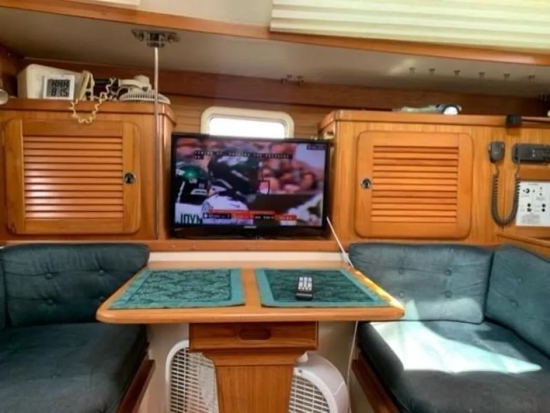Slide: The Image of Interior of a 1999 Catalina 36 Mark II sailboat with a TV and seating area. - 3