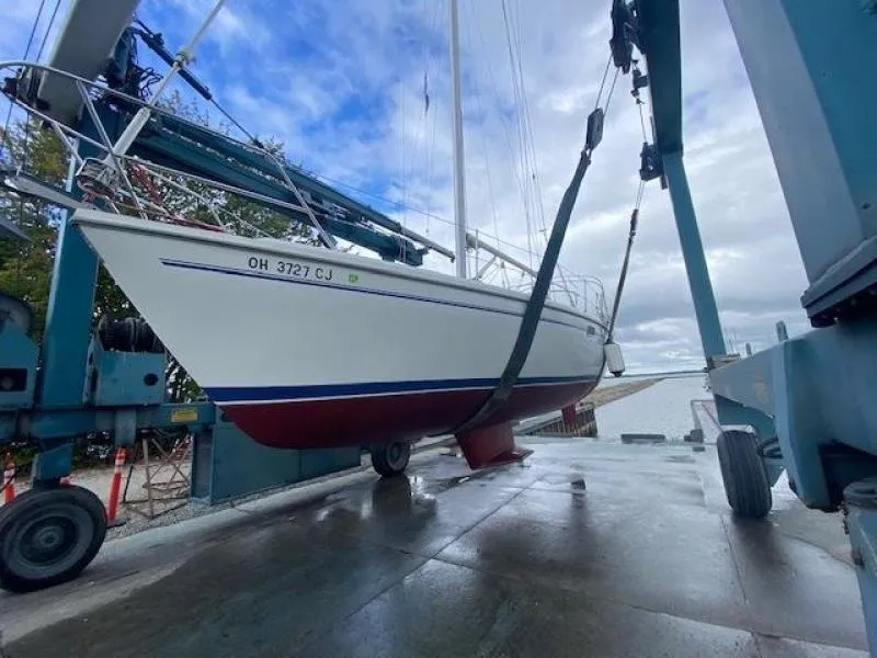 Slide: The Image of 1999 Catalina 36 Mark II sailboat being lifted by a boat hoist. - 19